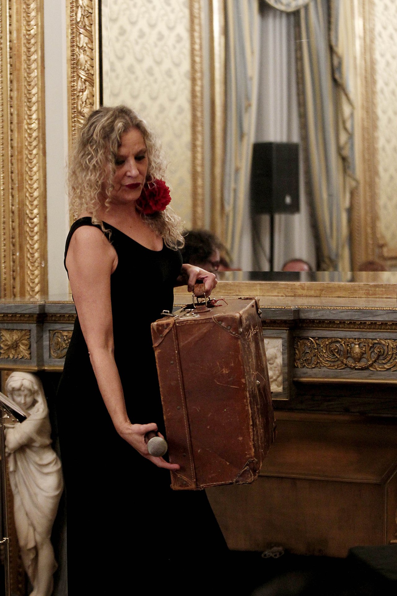 Mona con una maleta antigua en el concierto de la Casa de América